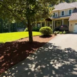 Front yard landscaping with fresh mulch installation and clean bed edging