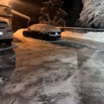 Night snow removal service clearing driveway after winter storm