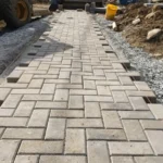 Paver patio installation project with clean layout and professional finishing
