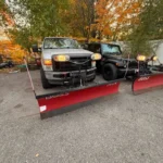 Professional snow plow equipment clearing heavy snowfall on driveway