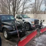 Residential driveway snow plowing service using professional truck and snow blade