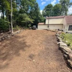 Residential hardscape installation service with structured paver layout